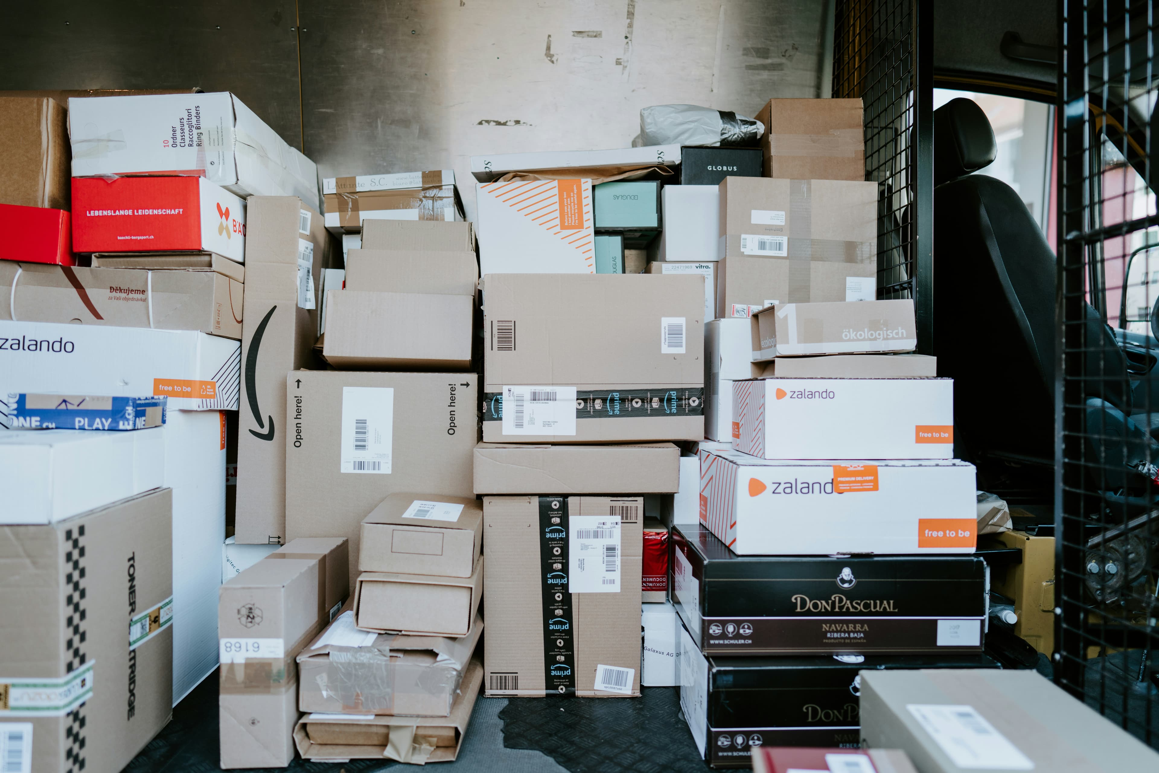 Stacked shipment parcels and delivery boxes ready for dispatch, representing logistics operations