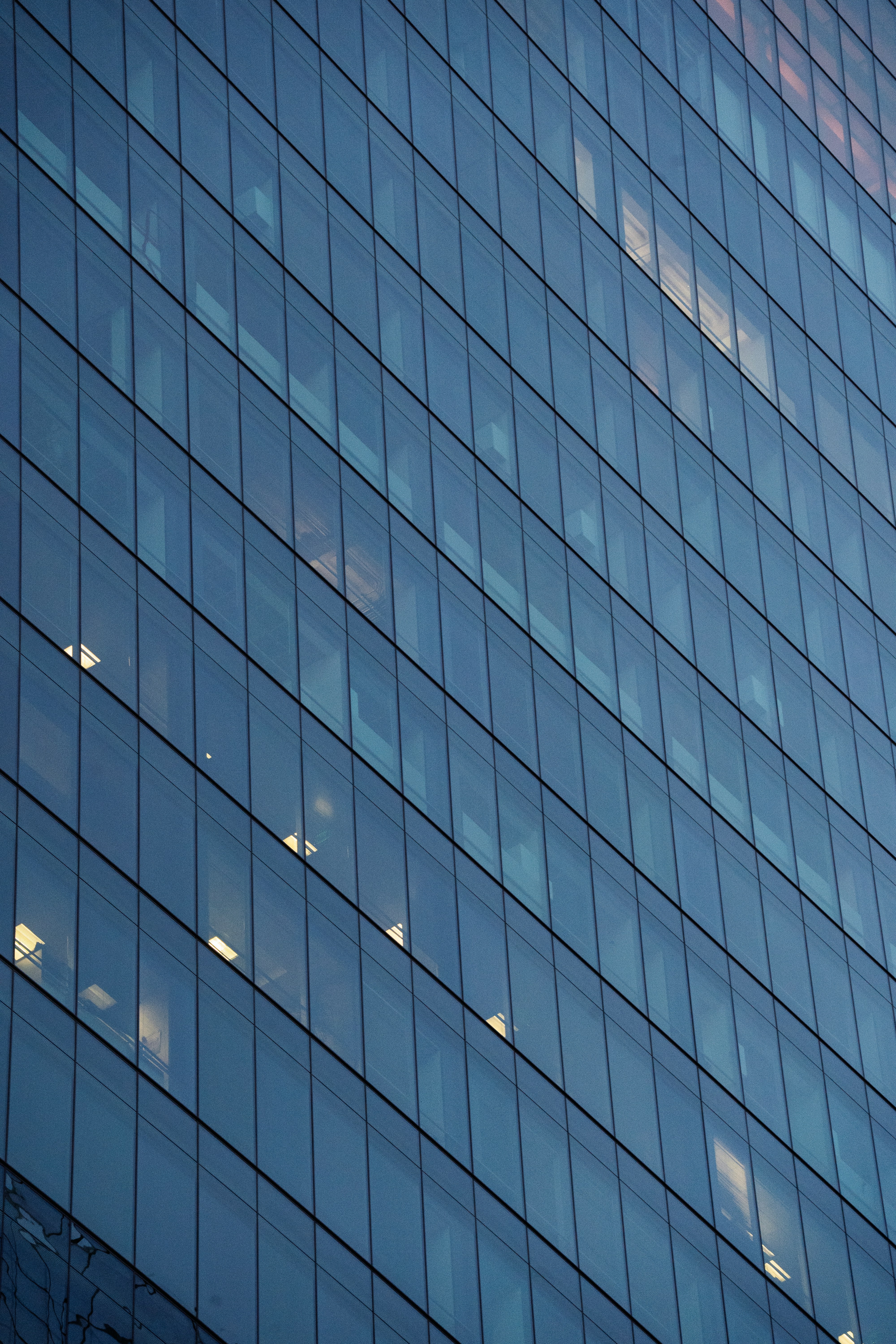 The glass facade of a modern office building